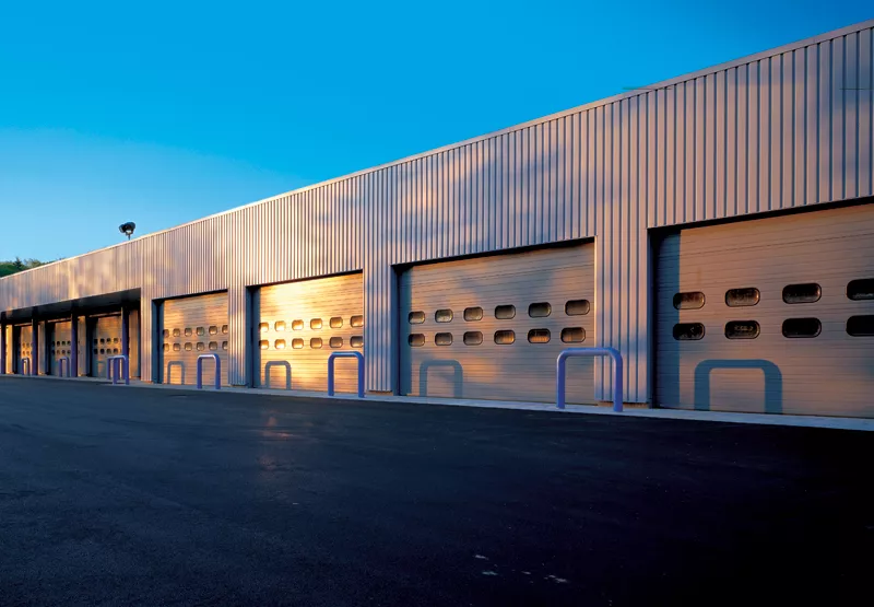 Large commercial building with a row of garage doors