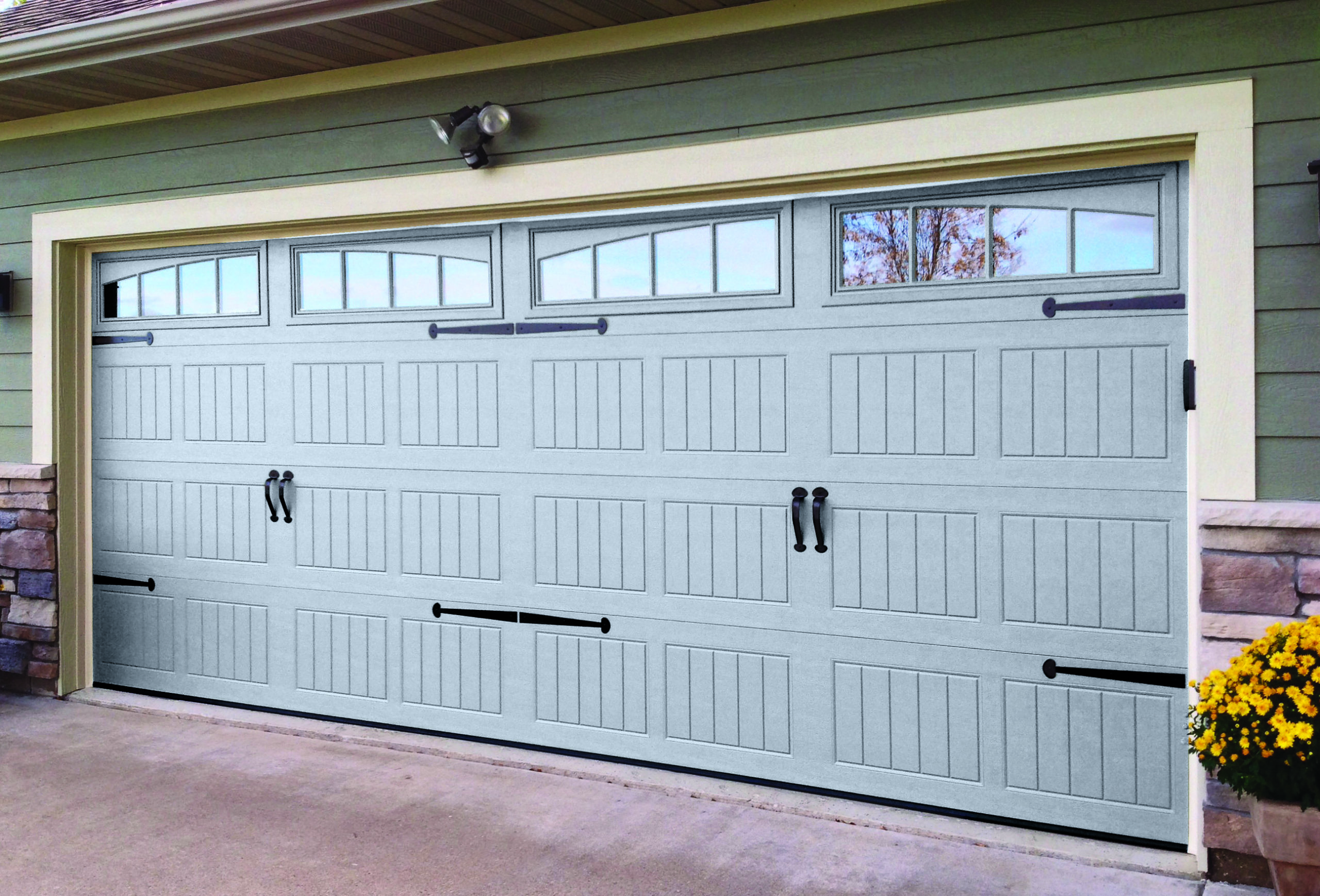 Light gray garage door with small windows at the top, for a two-car garage.