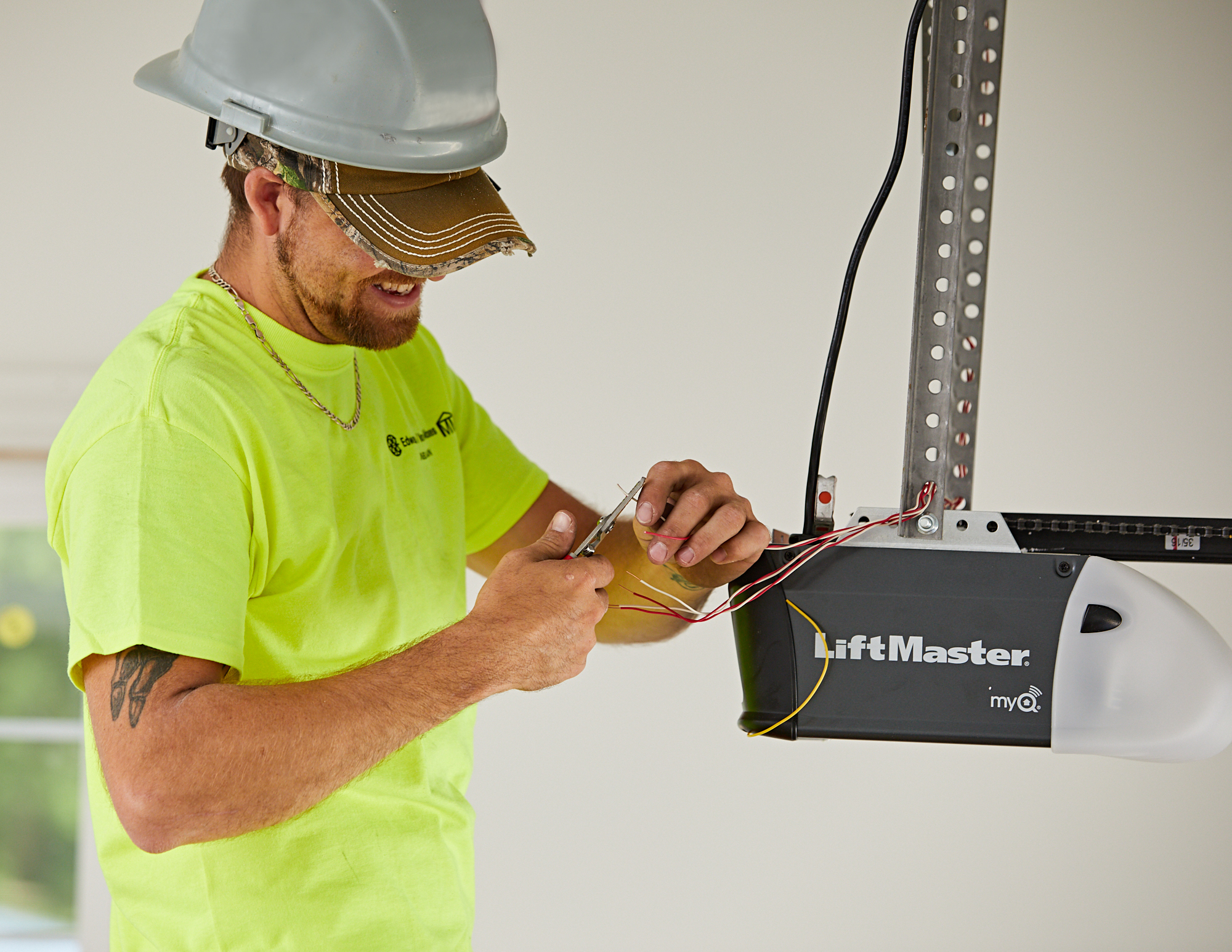 Technician servicing a garage door opener