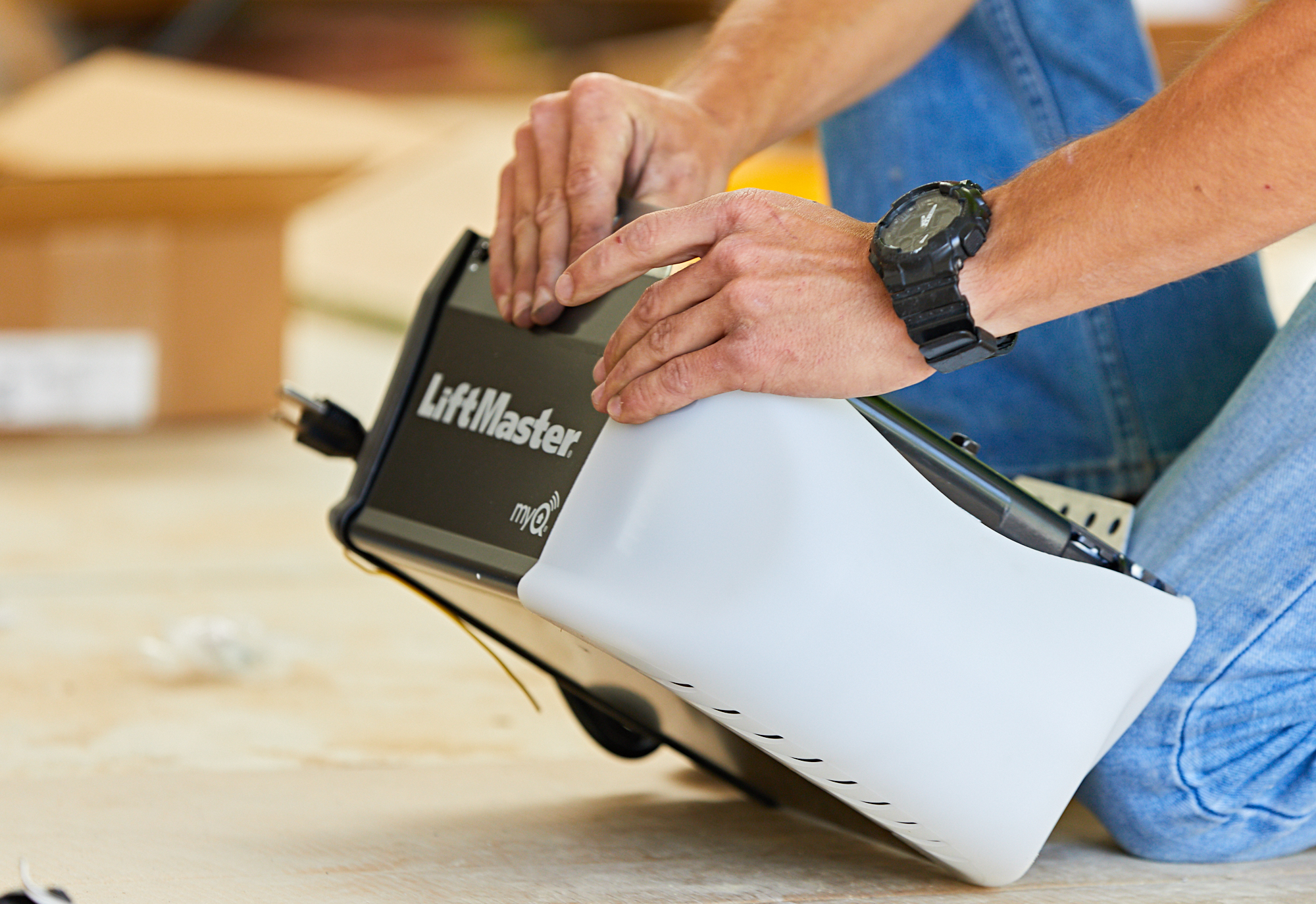 Technician preparing for a garage door opener installation