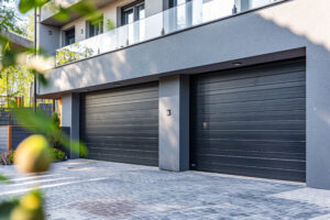 A detailed view of a two-car garage at a modern home. The garage doors are sleek and stylish, adding to the overall aesthetic of the house